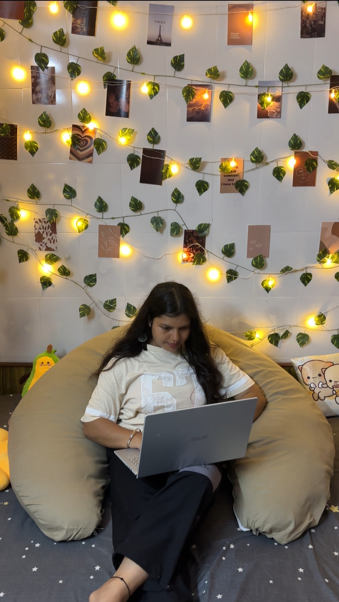 Woman working on a laptop while leaning back into the Diwan Body Pillow
